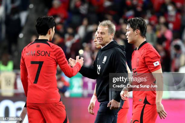 South Korea's new head coach Juergen Klinsmann shakes hands with Son Heung-min after the international friendly match between South Korea and...