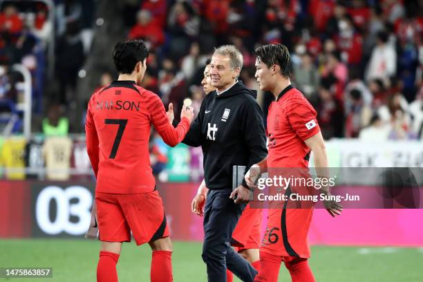 South Korea's new head coach Juergen Klinsmann shakes hands with Son Heung-min after the international friendly match between South Korea and...