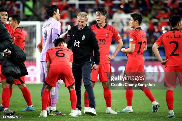 South Korea's new head coach Juergen Klinsmann shakes hands with Hwang In-beom after the international friendly match between South Korea and...