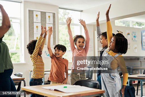 Kids, fun stretching and classroom hands in the air for happy children assessment growth in a school. Students, exercise and happiness of young group in a education study hall with student motivation