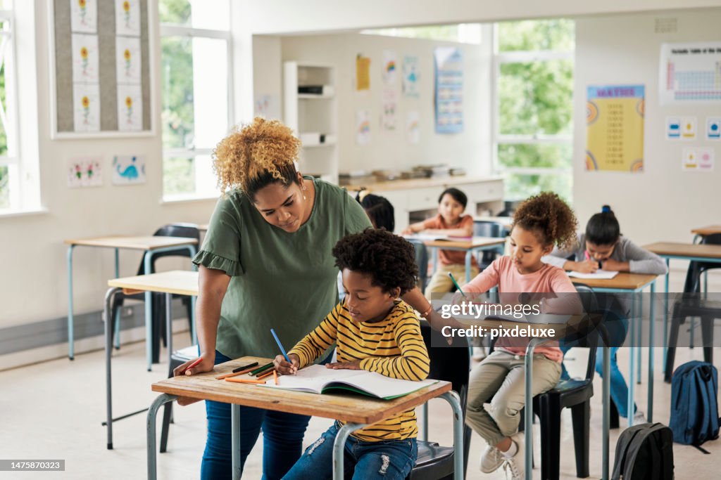 Children classroom help, teacher and test writing of kids in a exam lecture hall for knowledge. Education explanation, student learning and school employee in a study lesson with a young boy working