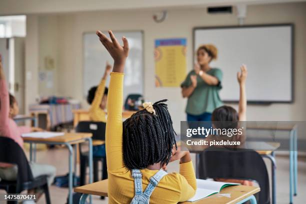 questions, teacher or education at school with kids hands raised to answer english language assessment. classroom, learning or tutor teaching summary information to smart and clever group of children - children raising their hands stock pictures, royalty-free photos & images