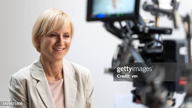 businesswoman giving corporate interview - studio interview stock pictures, royalty-free photos & images