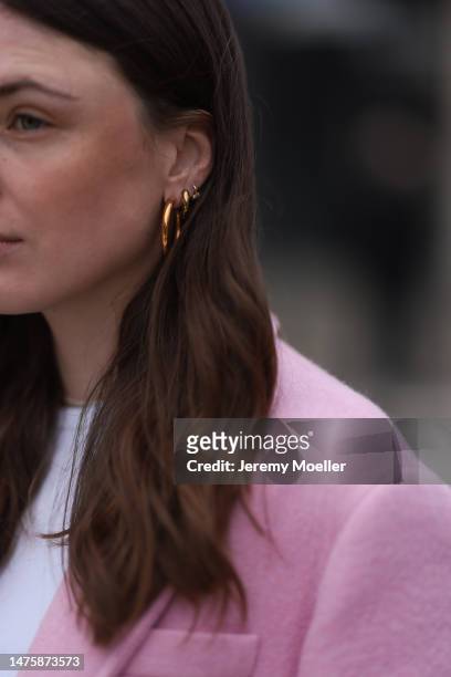 Karla Jenders seen wearing Yes My Love white top, Zara pink long coat, Ariane Ernst jewelry on March 20, 2023 in Cologne, Germany.