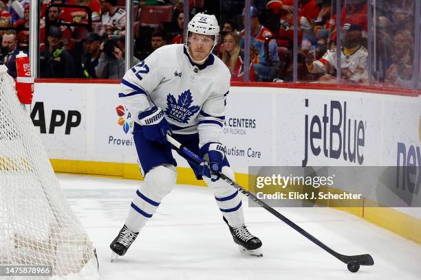 Jake McCabe of the Toronto Maple Leafs skates with the puck against the Florida Panthers at the FLA Live Arena on March 23, 2023 in Sunrise, Florida.