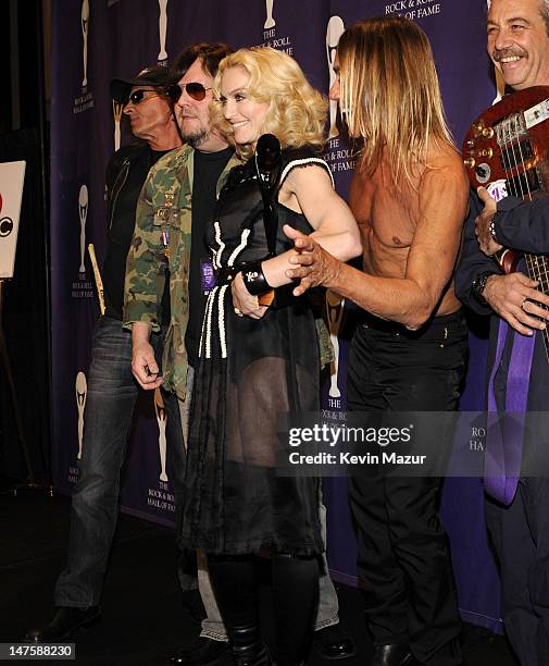 Inductee Madonna poses with Scott Asheton, Ron Asheton, Iggy Pop and Mike Watt of The Stooges in the press room at the 23rd Annual Rock and Roll Hall...