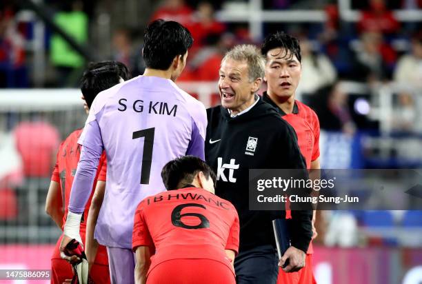 South Korea's new head coach Juergen Klinsmann shakes hands with Kim Seung-Gyu after the international friendly match between South Korea and...