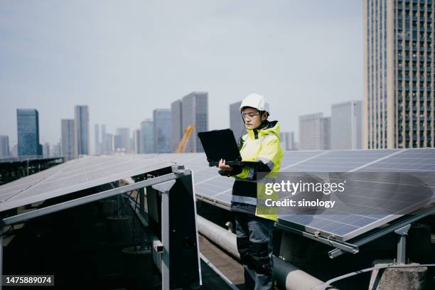 engineer work with laptop in solar power station - china factory stock pictures, royalty-free photos & images