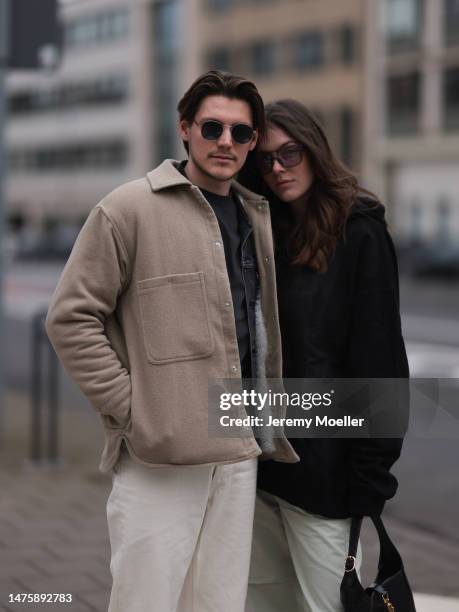 Mathis seen wearing Ray-Ban black sunglasses, Weekday grey cotton shirt, Weekday beige jacket, Weekday white denim pants. Karla Jenders seen wearing...