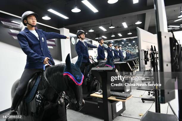 Students practice horsemanship skills on professional simulators during a lesson at the College of Sports and Leisure, Sichuan Tourism University on...