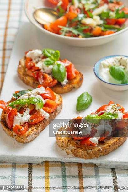 tomato and burrata cheese on toasted bread - bruschetta stock-fotos und bilder