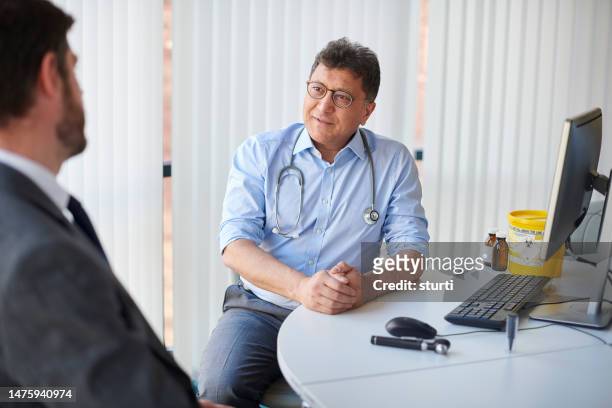 gp listening to sales pitch - patient in hospital stock pictures, royalty-free photos & images