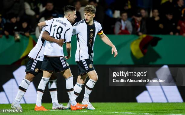 Denis Huseinbasic of Germany celebrates his side's second goal with his teammates during the Under-21 friendly match between Germany and Japan at PSD...