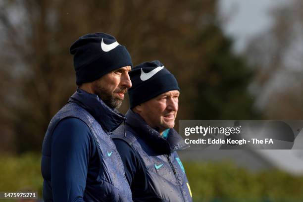 Gareth Southgate, Manager of England, and Steve Holland, Assistant Manager of England, look on during a training session at Spurs Lodge on March 24,...