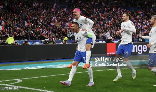 Antoine Griezmann of Team France celebrate his first goal with captain, Kylian Mbappe during the UEFA EURO 2024 qualifying round group B match...