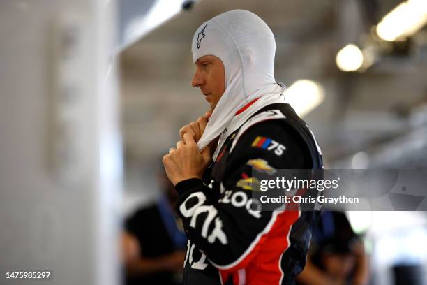 Kimi Raikkonen, driver of the Onx Homes/iLOQ Chevrolet, looks on in the garage area during practice for the NASCAR Cup Series EchoPark Automotive...