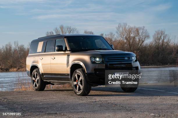 land rover defender 130 next to the river - land rover stock pictures, royalty-free photos & images
