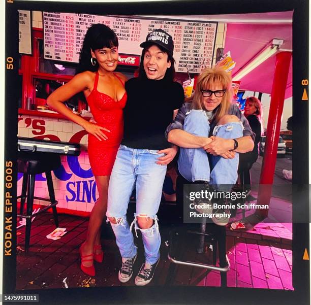 Mike Myers, Dana Carvey and Tia Carrere pose in character as their Wayne's World Characters at the iconic burger joint Irv's in West Hollywood in...