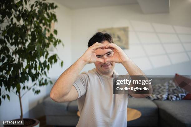 happy man with down syndrome enjoying at home - independence stock pictures, royalty-free photos & images