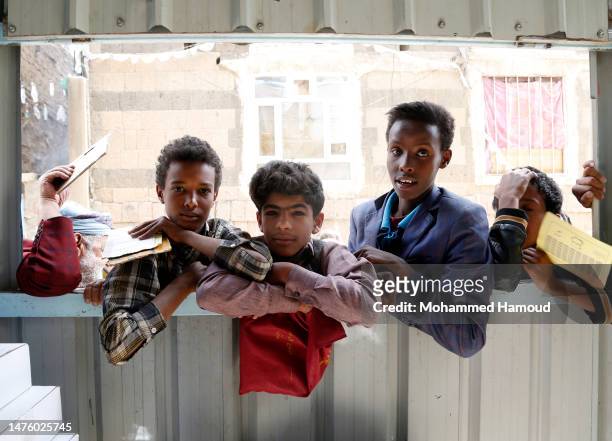 Children from families affected by eight years of war and blockade wait to receive free meals provided by a charitable kitchen in the Mseek area on...