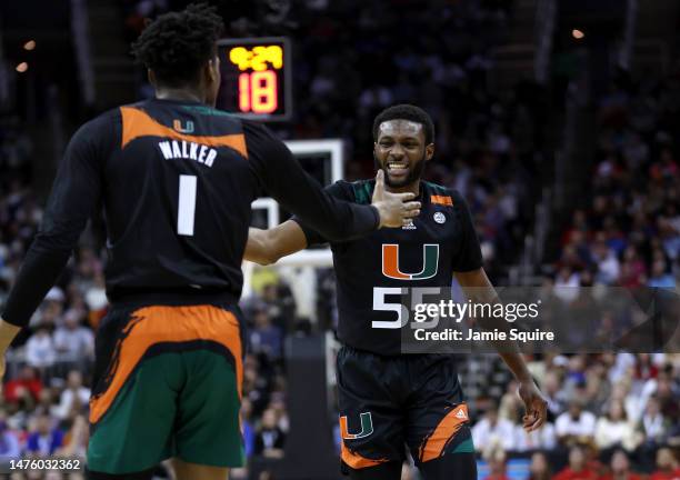 Wooga Poplar of the Miami Hurricanes celebrates scoring with teammate Anthony Walker against the Houston Cougars during the second half in the Sweet...