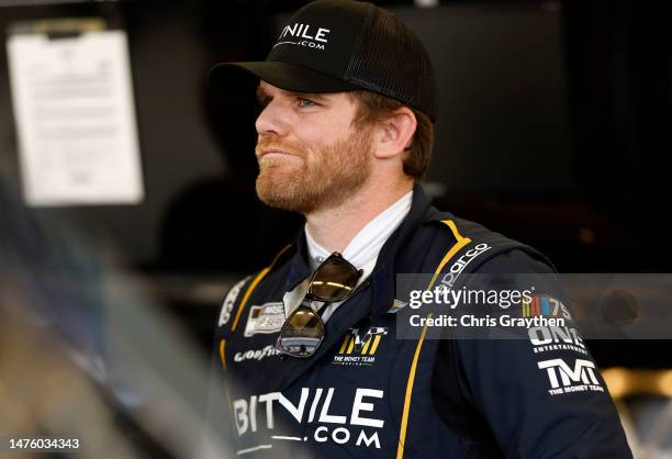 Conor Daly, driver of the BitNile.com Chevrolet, looks on in the garage area during practice for the NASCAR Cup Series EchoPark Automotive Grand Prix...