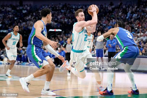 Gordon Hayward of the Charlotte Hornets makes a move to the basket between Josh Green and Jaden Hardy of the Dallas Mavericks during the first half...