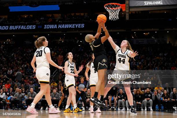 Quay Miller of the Colorado Buffaloes shoots the ball over Addison O'Grady of the Iowa Hawkeyes during the fourth quarter in the Sweet 16 round of...