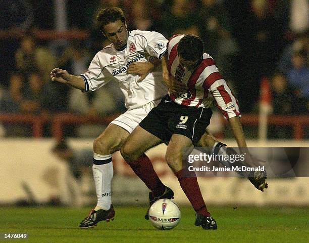 Kevin O'Connor of Brentford holds off Mark Wilson of Middlesbrough during the Worthington Cup Second Round match between Brentford and Middlesbrough...