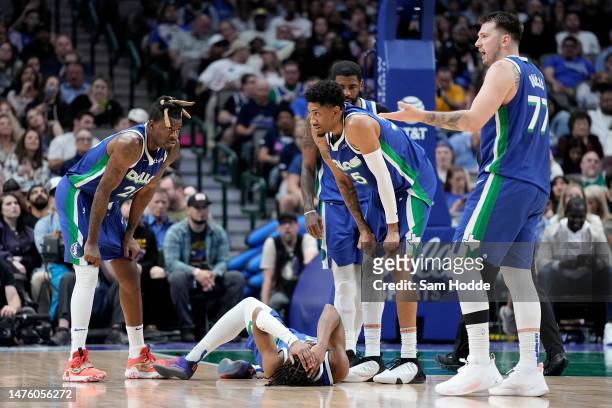 Luka Doncic of the Dallas Mavericks gestures to the sideline as teammate Jaden Hardy lays on the court during the second half against the Charlotte...