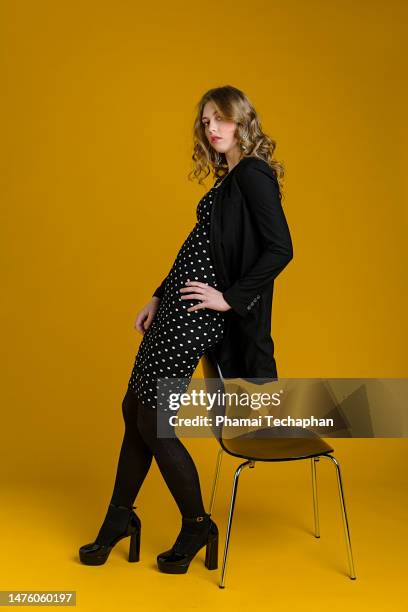 fashionable young woman on plain background - form fitted dress stock pictures, royalty-free photos & images