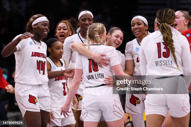 The Louisville Cardinals celebrate after defeating the Ole Miss Rebels in the Sweet 16 round of the NCAA Women's Basketball Tournament at Climate...