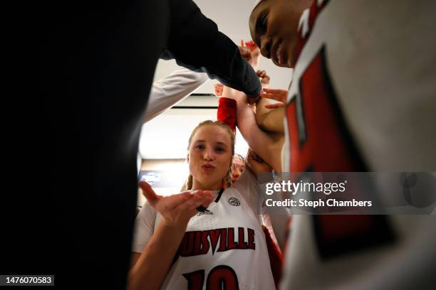 Hailey Van Lith of the Louisville Cardinals celebrates with teammates after defeating the Ole Miss Rebels in the Sweet 16 round of the NCAA Women's...