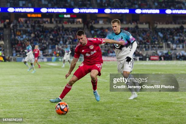 Sean Nealis of the New York Red Bulls and Robin Lod of Minnesota United FC go for the ball during a game between New York Red Bulls and Minnesota...