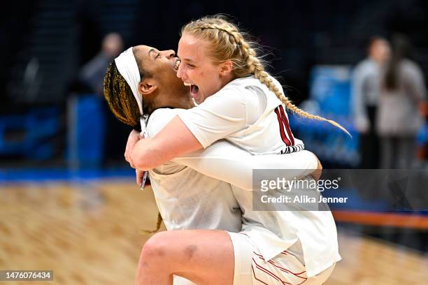 Merissah Russell and Hailey Van Lith of the Louisville Cardinals celebrate after defeating the Ole Miss Rebels in the Sweet 16 round of the NCAA...