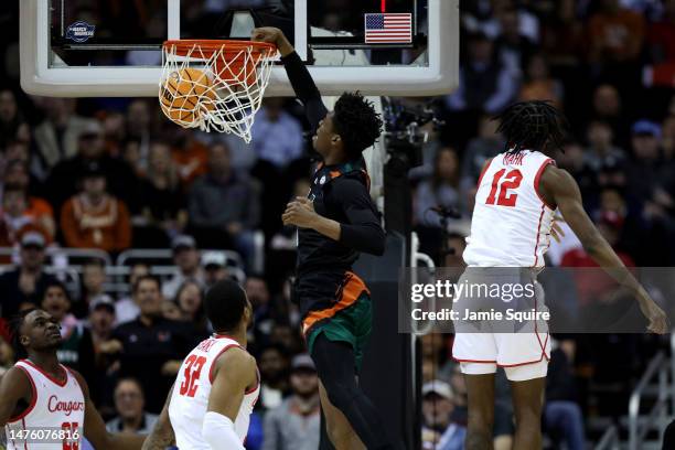 Anthony Walker of the Miami Hurricanes dunks the ball against the Houston Cougars during the first half in the Sweet 16 round of the NCAA Men's...