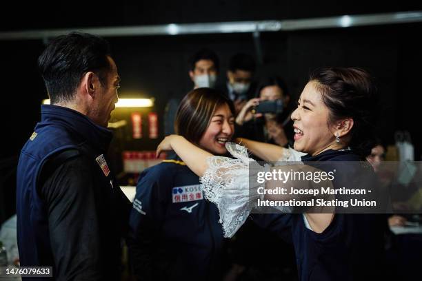 Kana Muramoto and Daisuke Takahashi of Japan are congratulated by Kaori Sakamoto of Japan compete in the Ice Dance Free Dance during the ISU World...