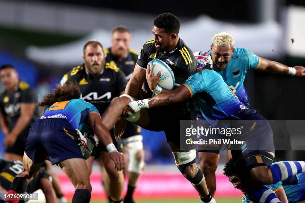 Ardie Savea of the Hurricanes is tackled during the round five Super Rugby Pacific match between Moana Pasifika and Hurricanes at Mt Smart Stadium,...