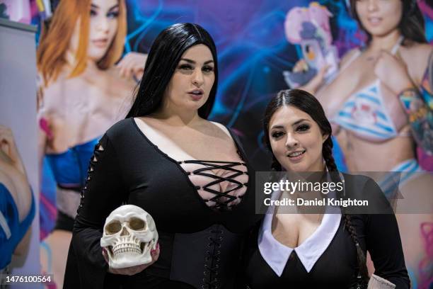 Entertainers Abigail Morris as Morticia Addams and Sammy Torres as Wednesday Addams pose on Day 1 of WonderCon 2023 at Anaheim Convention Center on...