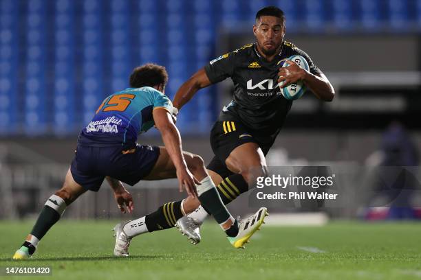 Salesi Rayasi of the Hurricanes is tackled during the round five Super Rugby Pacific match between Moana Pasifika and Hurricanes at Mt Smart Stadium,...