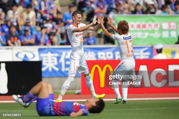 Milivoje Novakovic of Omiya Ardija celebrates with teammate Daigo Watanabe after scoring the team's third goal during the J.League J1 match between...