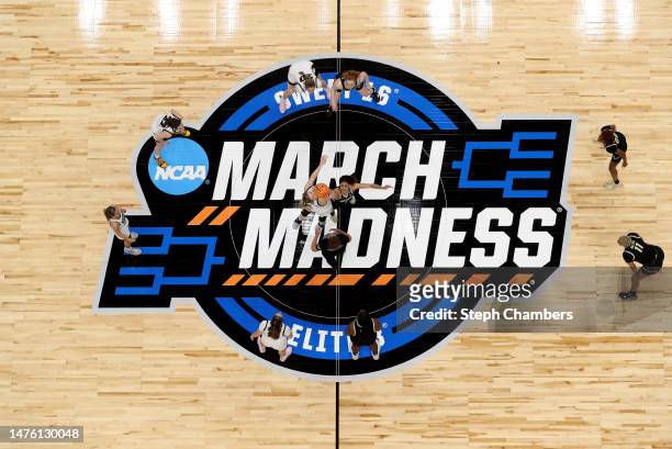 Monika Czinano of the Iowa Hawkeyes and Tayanna Jones of the Colorado Buffaloes reach for the opening tip-off in the Sweet 16 round of the NCAA...