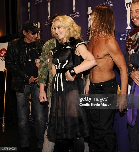 Inductee Madonna poses with Scott Asheton and Iggy Pop of The Stooges in the press room at the 23rd Annual Rock and Roll Hall of Fame Induction...