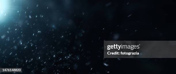 dust defocused particles against dark gradient background - nevar fotografías e imágenes de stock