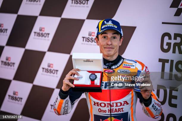Marc Marquez of Spain and Repsol Honda Team shows his Tissot watch, after he won the pole position during the qualifying session of the MotoGP Grande...