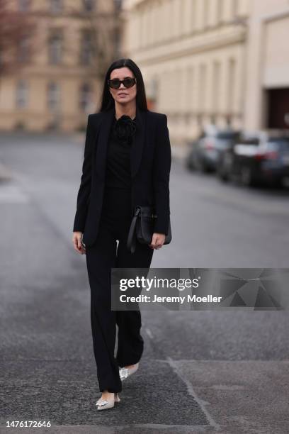 Leo Eberlin seen wearing YSL brown sunglasses, Leo Mathild diamond jewellery, Zara black rose top, Zara black blazer and matching black suit pants,...