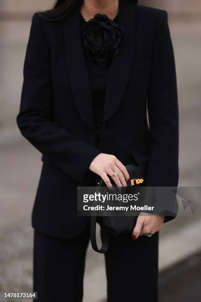 Leo Eberlin is seen wearing Leo Mathild diamond jewellery, Zara black rose top, Zara black blazer and matching black suit pants, Hermès black leather...