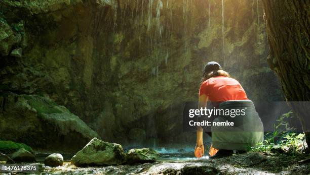 woman in forest enjoying nature under tropical fresh waterfall - running water isolated stock pictures, royalty-free photos & images