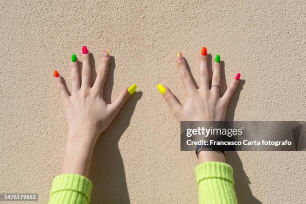 woman's hands with multicolored nail polish - multi coloured nails stock pictures, royalty-free photos & images