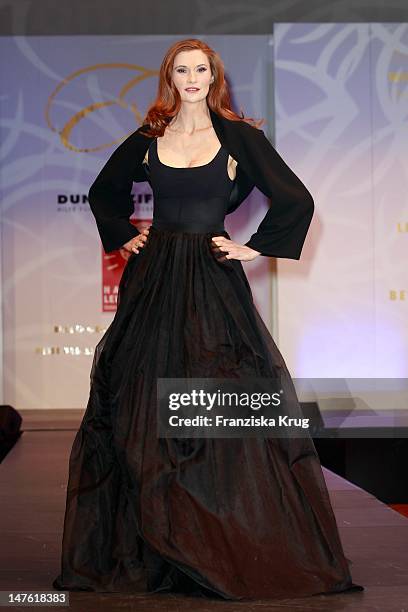 Karina Krawczyk shows designs on the catwalk during the charity event 'Event Prominent' at the Hotel Grand Elysee on March 25, 2012 in Hamburg,...